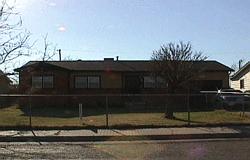 5132 South Bonham Street Amarillo, TX 79110 - Photo 1 of 1 a black white building with a tree in front of it