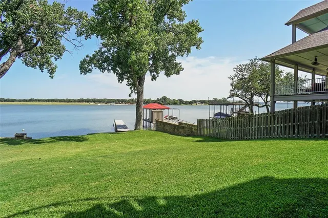 a view of a big building with a big yard and large trees