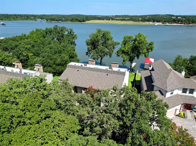 an aerial view of a house with outdoor space and sitting area