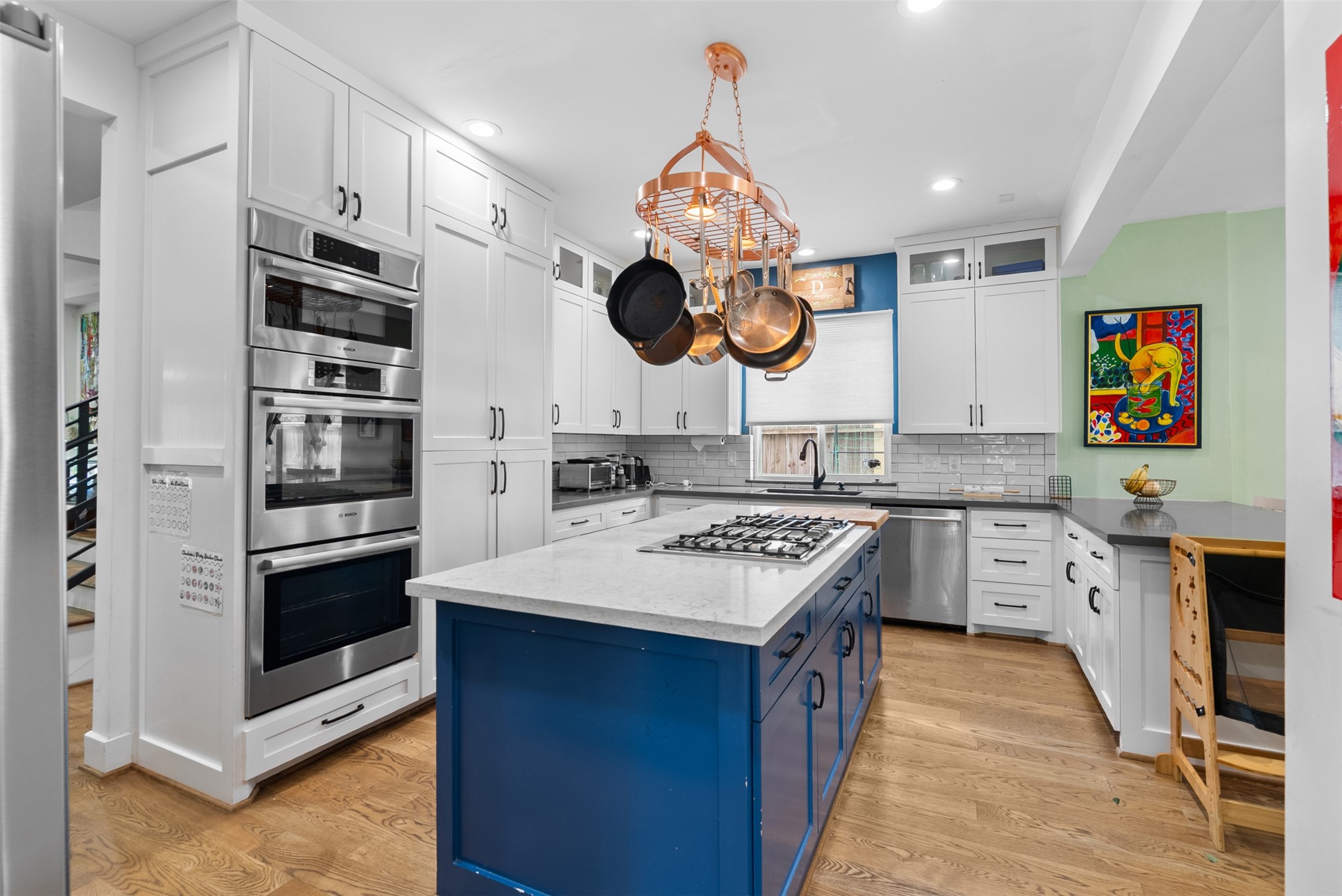 4503 McKinney Street Houston, TX 77023 - Photo 13 of 37 a kitchen with a stove cabinets and a wooden floor