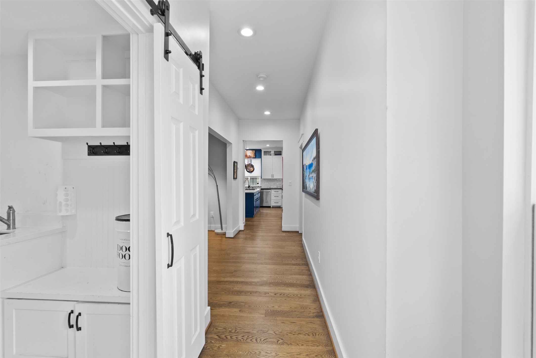 4503 McKinney Street Houston, TX 77023 - Photo 21 of 37 a view of a hallway with wooden floor and staircase
