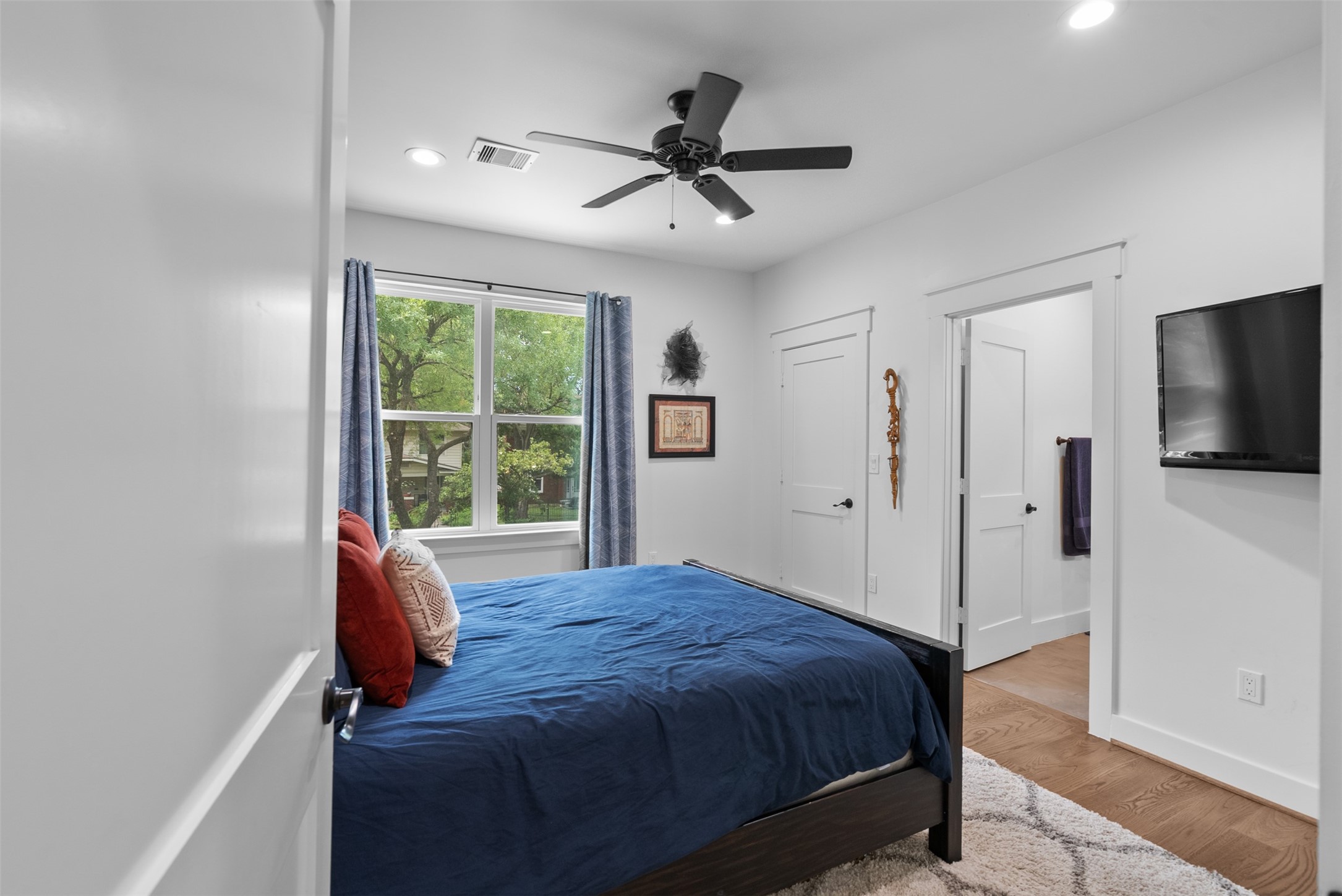 4503 McKinney Street Houston, TX 77023 - Photo 30 of 37 a bedroom with a bed and a flat screen tv