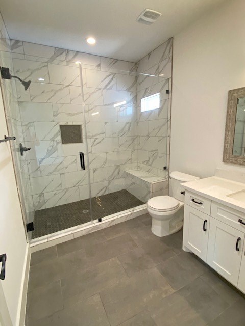 4503 McKinney Street Houston, TX 77023 - Photo 31 of 37 a bathroom with a granite countertop sink a toilet and shower