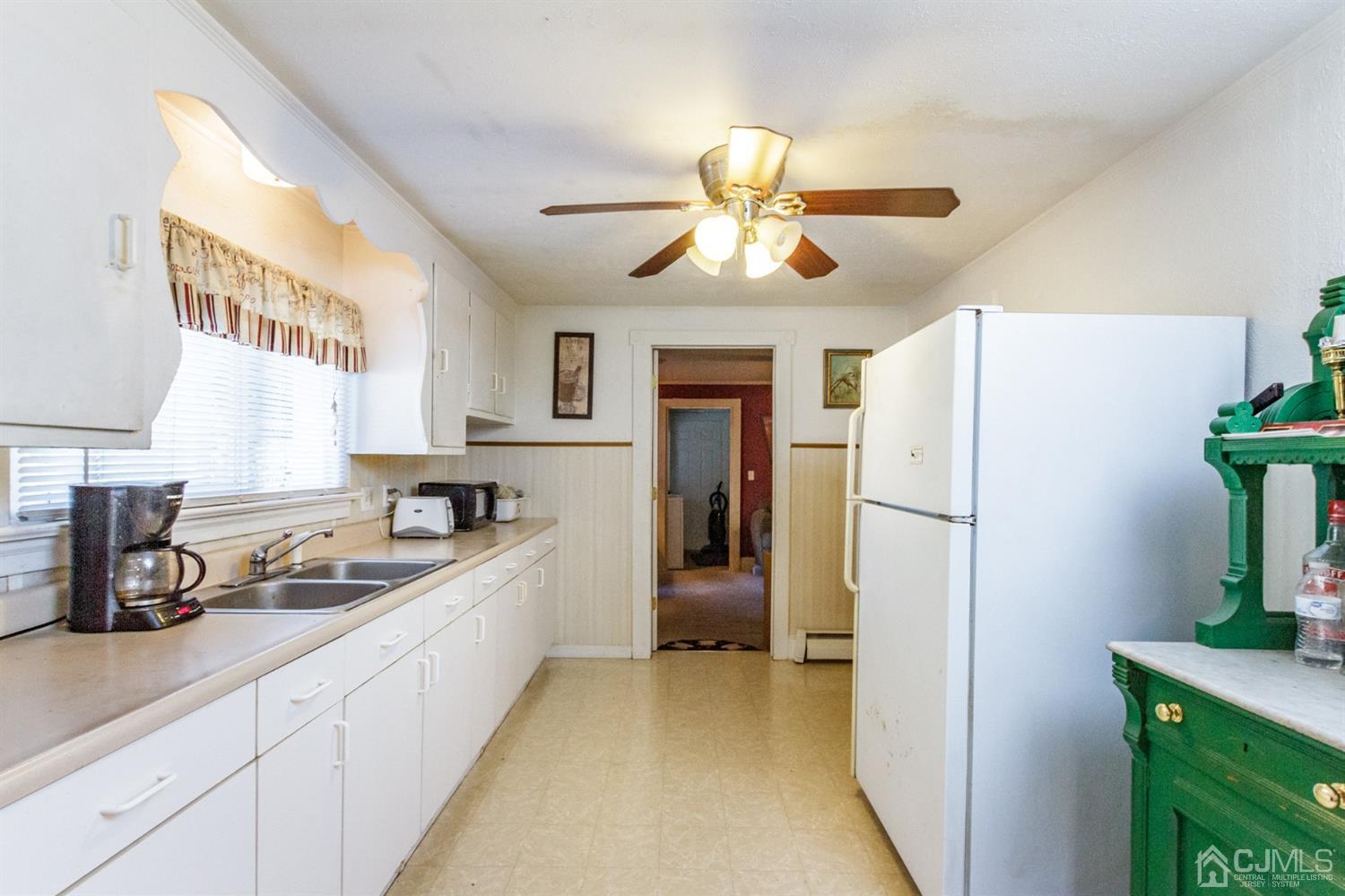 104 Oak Grove Road Flemington, NJ 08822 - Photo 3 of 25 a kitchen with a refrigerator and a sink