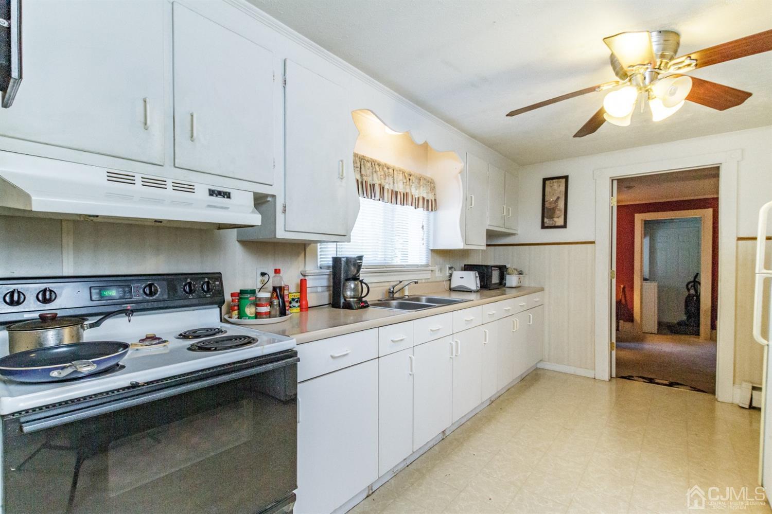 104 Oak Grove Road Flemington, NJ 08822 - Photo 4 of 25 a kitchen with stainless steel appliances granite countertop a sink and cabinets