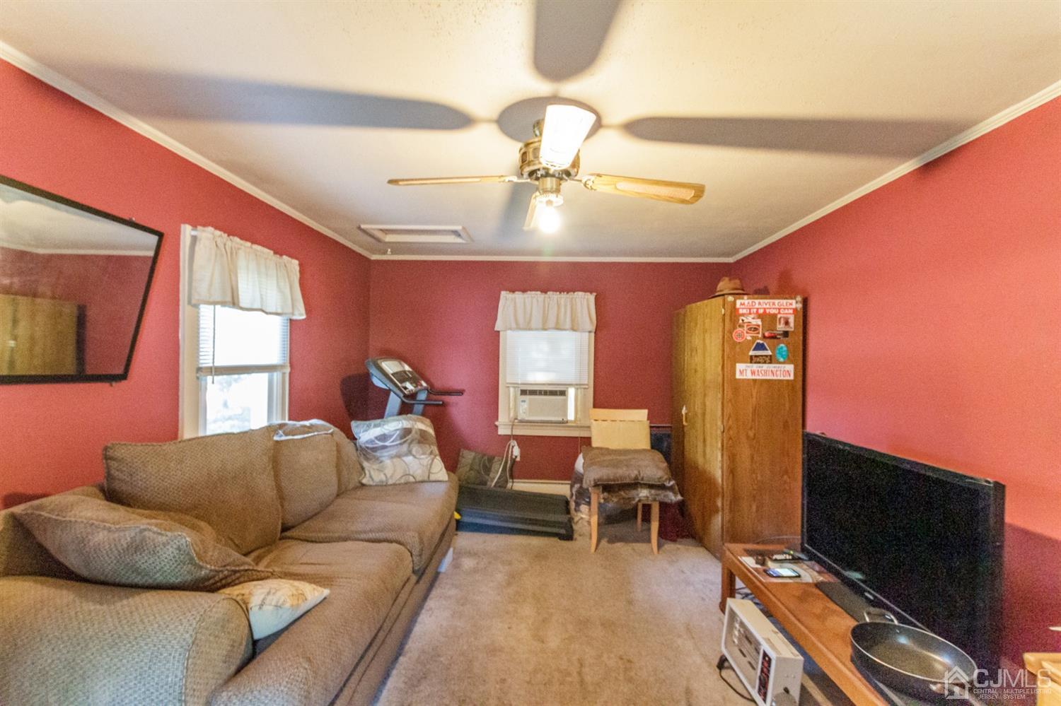104 Oak Grove Road Flemington, NJ 08822 - Photo 5 of 25 a living room with furniture a chandelier and a flat screen tv