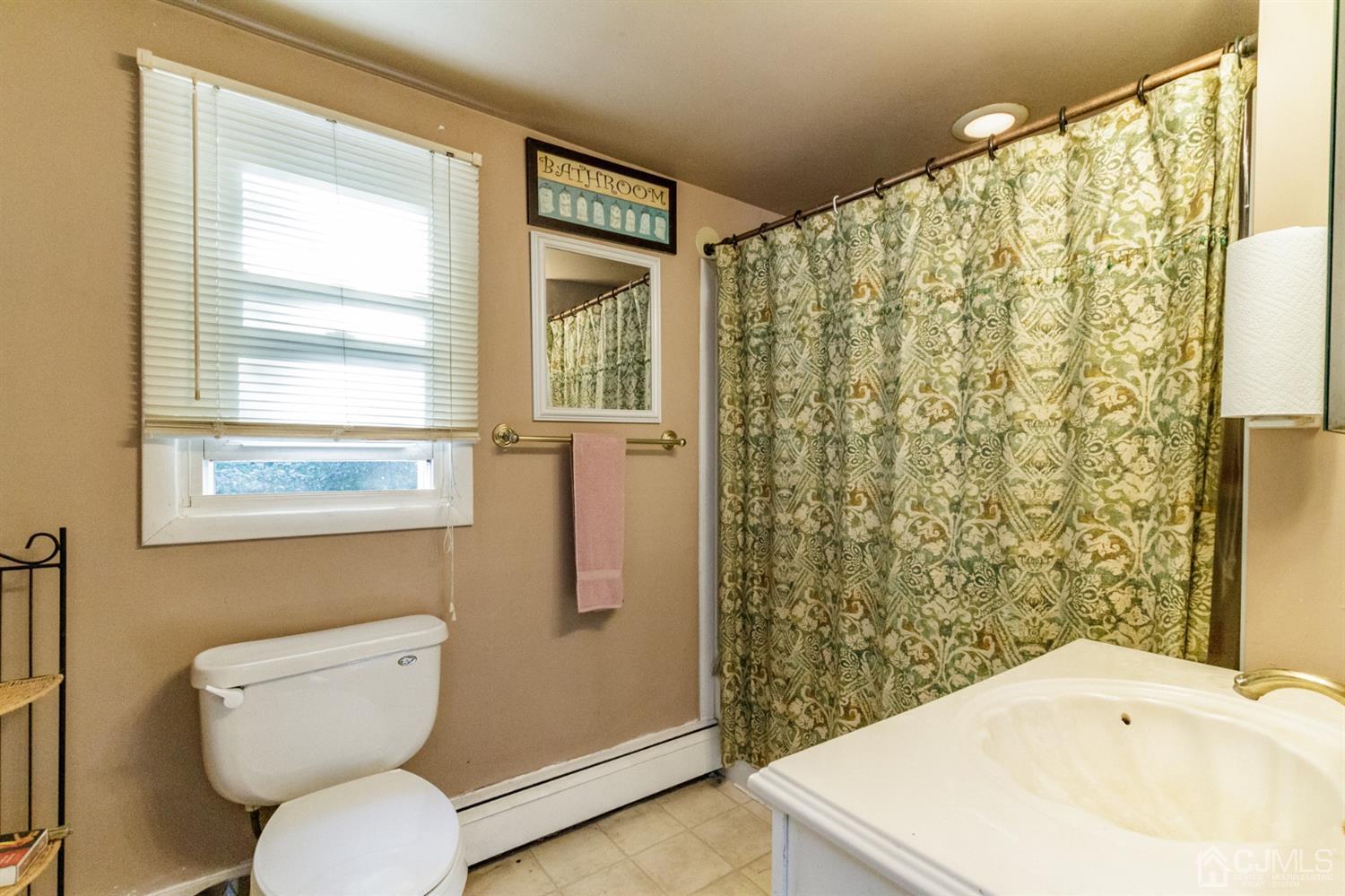 104 Oak Grove Road Flemington, NJ 08822 - Photo 8 of 25 a bathroom with a sink a toilet and shower