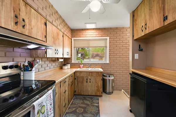 a kitchen that has a sink and a stove