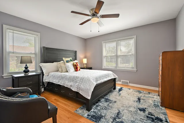 a bedroom with a bed a couch and a window