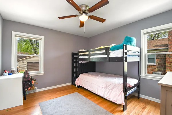 a bedroom with a bed and windows