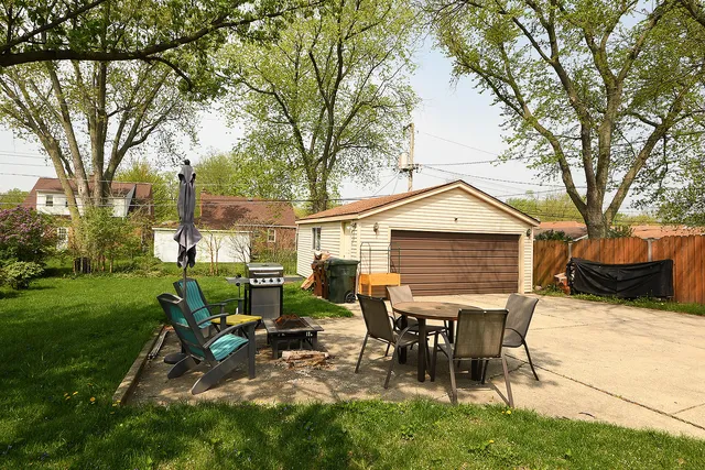 a view of a house with patio and a yard