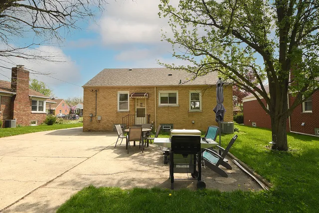 a view of a house with backyard sitting area and garden