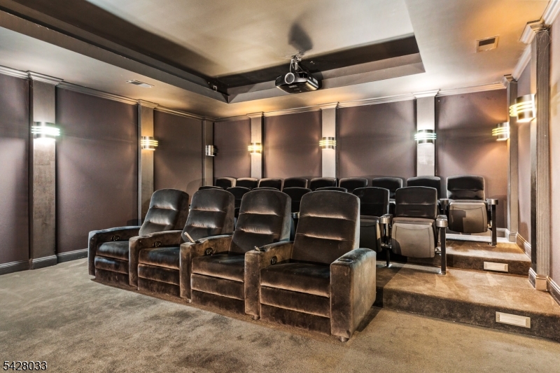 2 Chilton Road Chester, NJ 07930 - Photo 34 of 43 a media room with lots of chairs and a projector