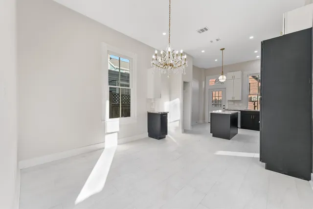 a large kitchen with a sink stainless steel appliances and cabinets