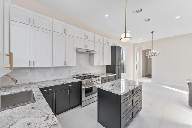 a kitchen with a sink stove and cabinets