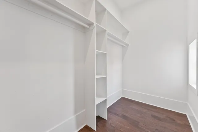 a bathroom with a granite countertop sink a toilet a mirror and shower