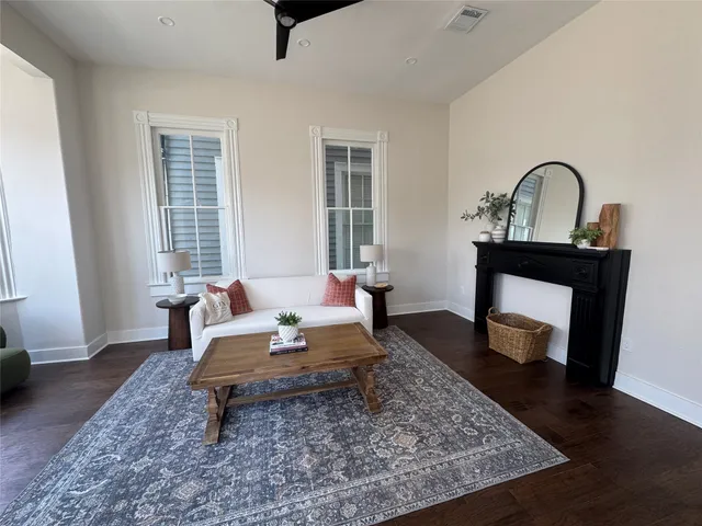 a living room with furniture and a wooden floor