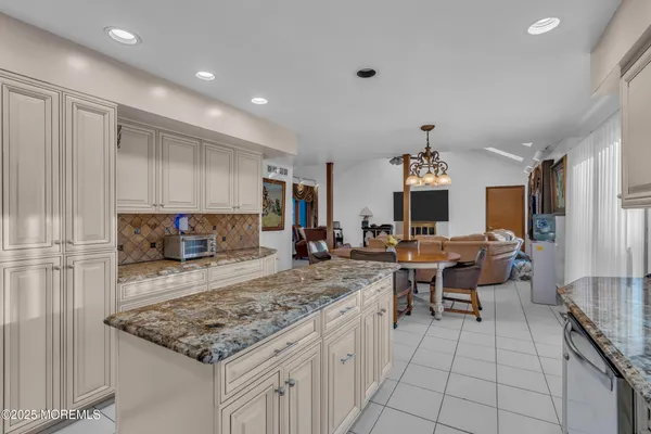 a view of a kitchen with kitchen island a sink table and chairs