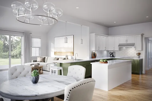 a kitchen with stainless steel appliances granite countertop a stove a sink a dining table and chairs