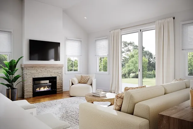 a living room with furniture a fireplace and a flat screen tv