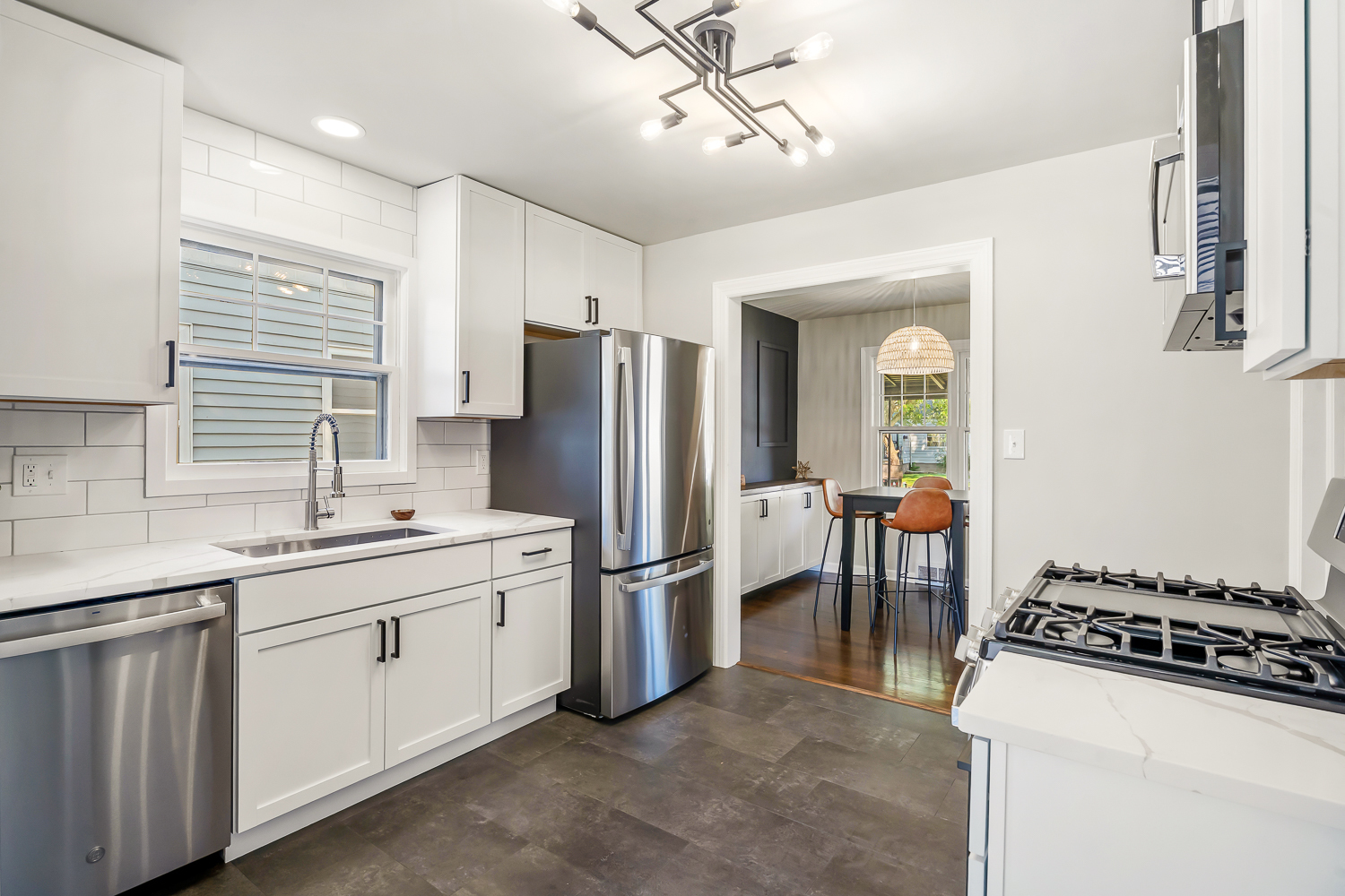 18540 Miller Drive Lansing, IL 60438 - Photo 15 of 57 a kitchen with stainless steel appliances a sink a stove a refrigerator cabinets and a dining table
