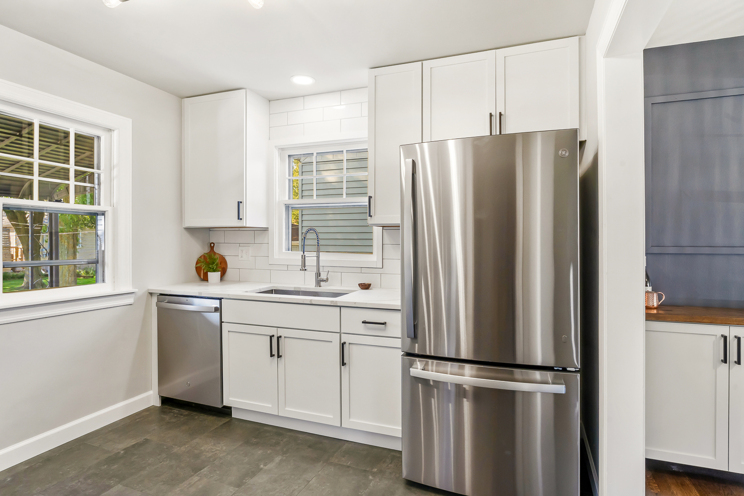 18540 Miller Drive Lansing, IL 60438 - Photo 17 of 57 a kitchen with stainless steel appliances a refrigerator sink and cabinets