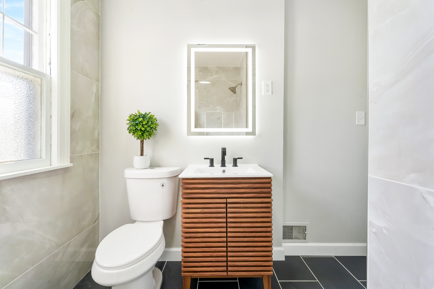18540 Miller Drive Lansing, IL 60438 - Photo 22 of 57 a bathroom with a toilet a sink and a window