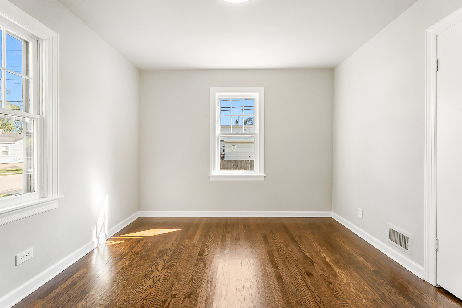 18540 Miller Drive Lansing, IL 60438 - Photo 24 of 57 an empty room with wooden floor and windows