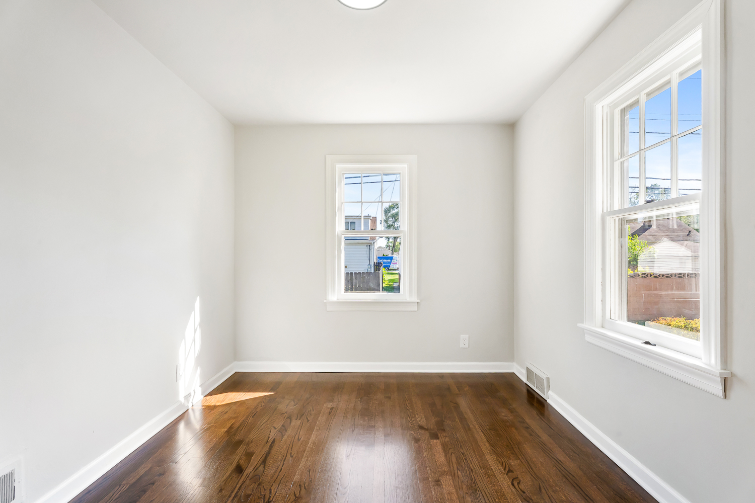 18540 Miller Drive Lansing, IL 60438 - Photo 26 of 57 an empty room with wooden floor and windows