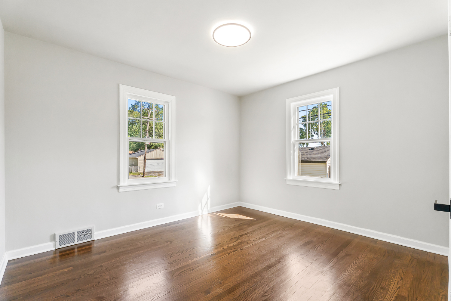 18540 Miller Drive Lansing, IL 60438 - Photo 30 of 57 an empty room with wooden floor and windows