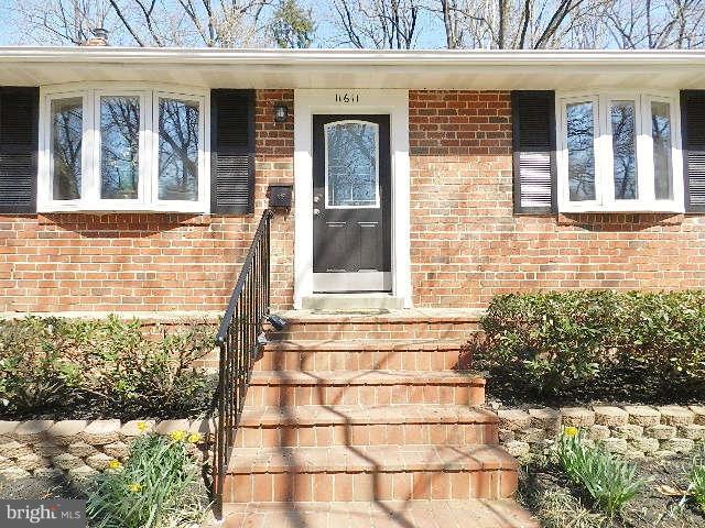 11611 Gail Street Silver Spring, MD 20902 - Photo 1 of 30 a view of a brick house with a large window