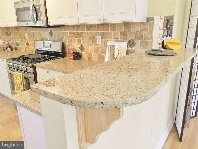 11611 Gail Street Silver Spring, MD 20902 - Photo 11 of 30 a kitchen with sink a stove and a microwave