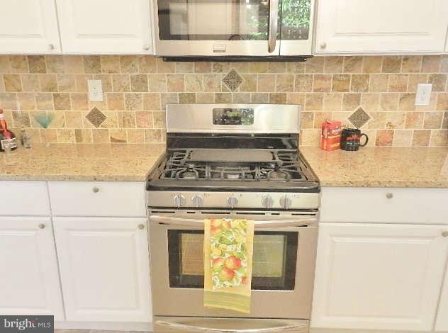 11611 Gail Street Silver Spring, MD 20902 - Photo 12 of 30 a stove top oven sitting inside of a kitchen