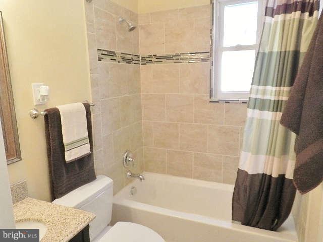 11611 Gail Street Silver Spring, MD 20902 - Photo 7 of 30 a bathroom with a shower curtain and a bathtub