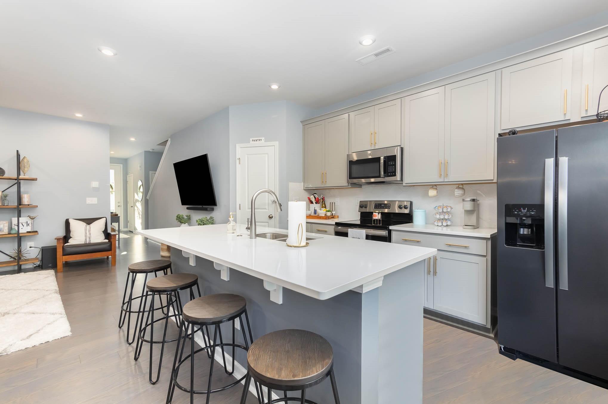 514 Madison Falls Fort Mill, SC 29708 - Photo 8 of 29 a kitchen with stainless steel appliances a stove a sink a microwave a refrigerator and cabinets