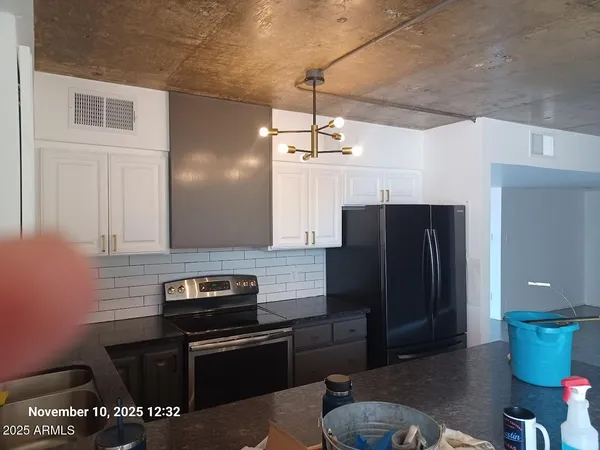 a kitchen with stainless steel appliances granite countertop a refrigerator and a stove