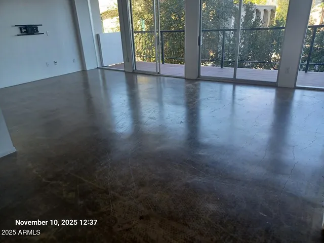 a living room with furniture a window and a glass door