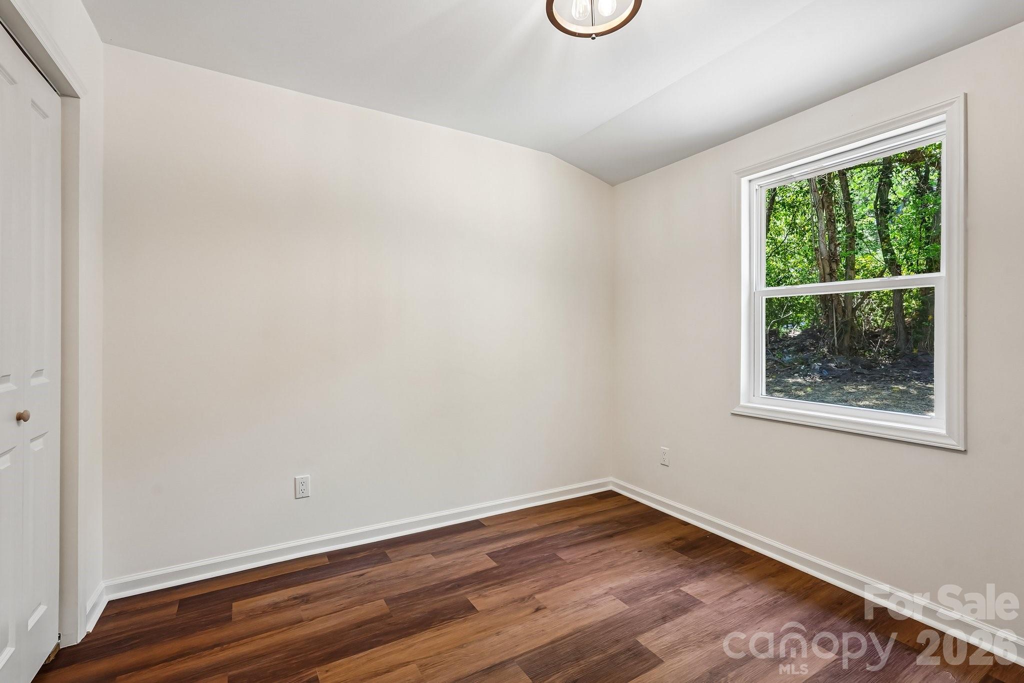 514 West Arch Street Lancaster, SC 29720 - Photo 24 of 43 a view of an empty room with wooden floor and a window