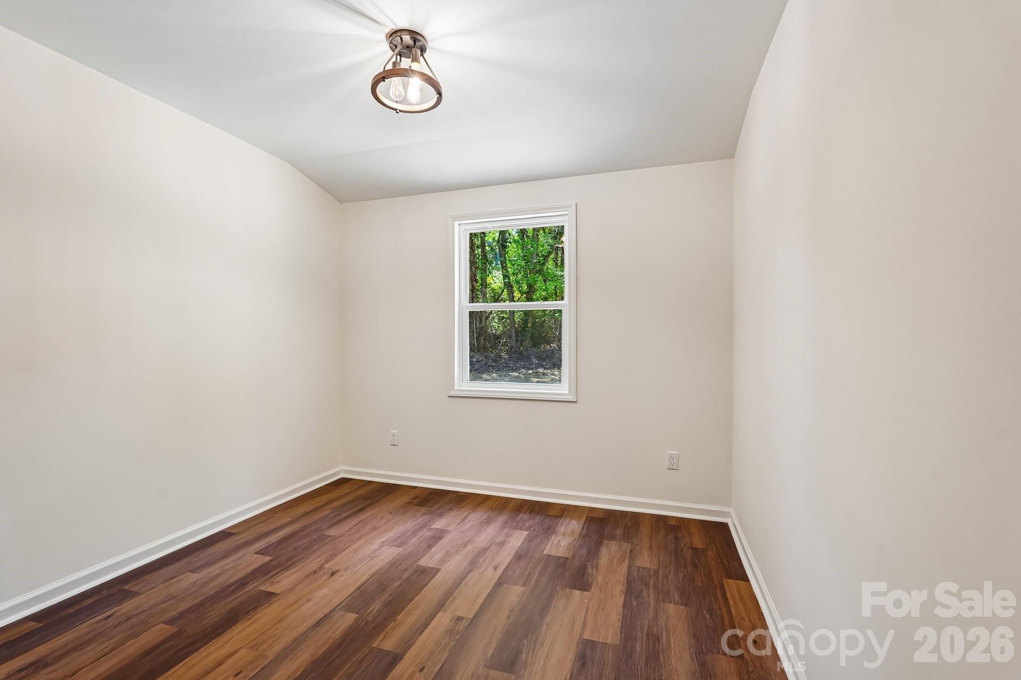 514 West Arch Street Lancaster, SC 29720 - Photo 35 of 43 a view of a room with wooden floor and window