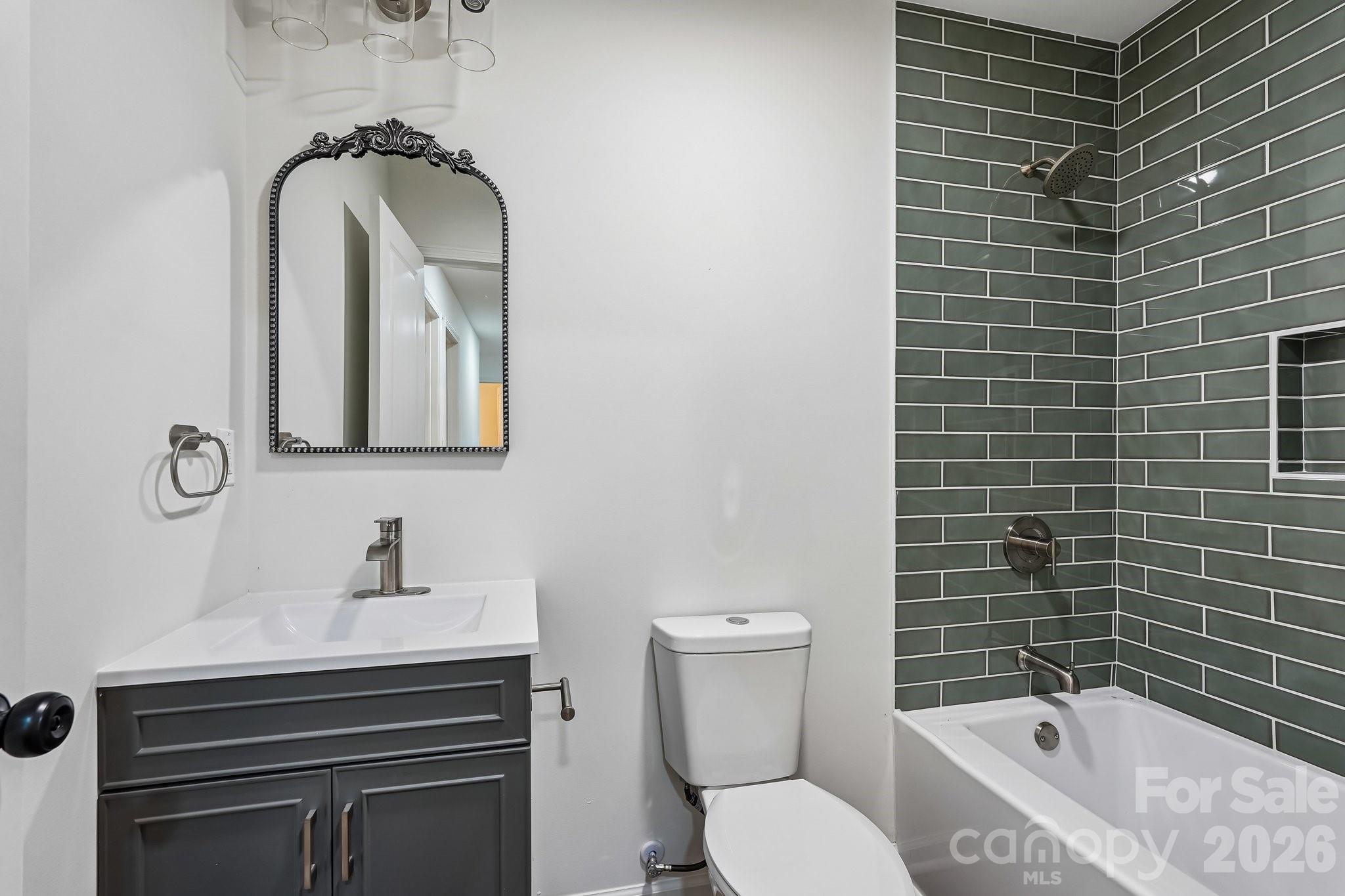 514 West Arch Street Lancaster, SC 29720 - Photo 9 of 43 a bathroom with a toilet sink and mirror