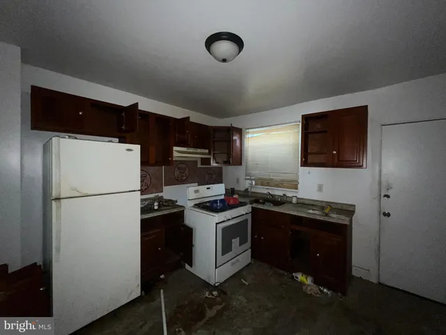 a kitchen with stainless steel appliances a refrigerator a stove a sink and a refrigerator