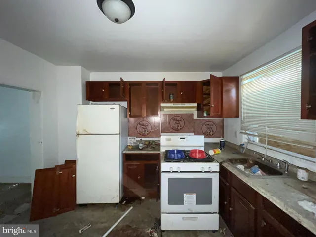 a kitchen with stainless steel appliances granite countertop a stove a refrigerator and a sink