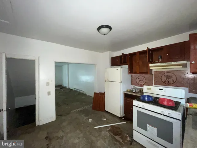 a kitchen with a stove and a refrigerator
