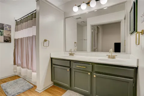 a bathroom with a double vanity sink and mirror