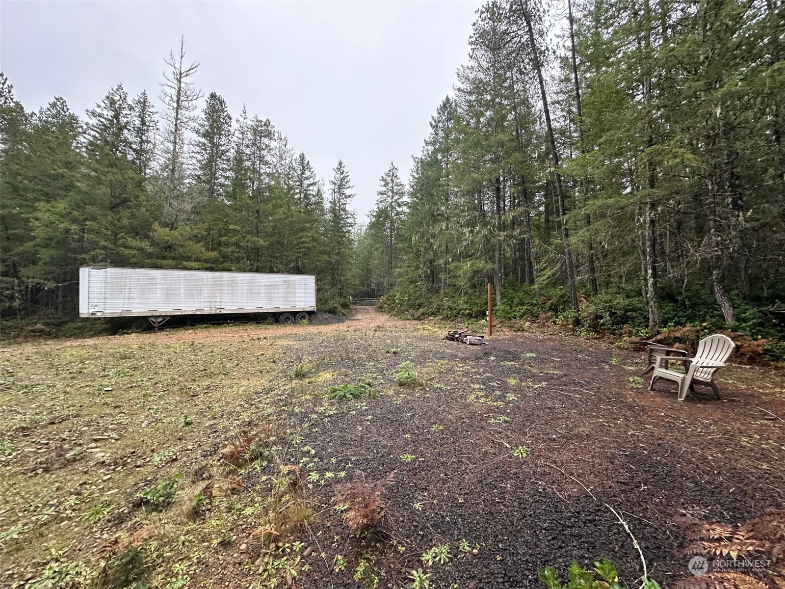 151 Northeast Bedrock Road Belfair, WA 98528 - Photo 23 of 27 a backyard of a house with table and chairs