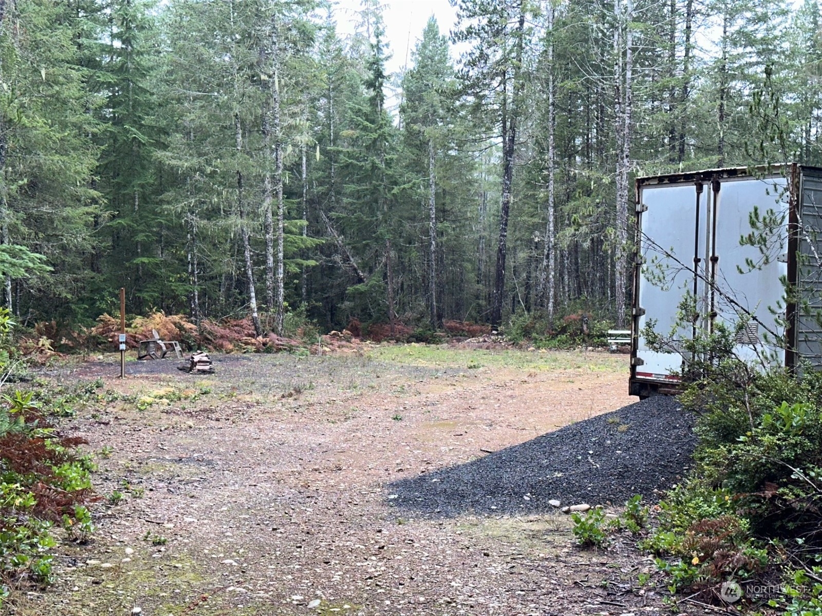 151 Northeast Bedrock Road Belfair, WA 98528 - Photo 6 of 27 a view of a backyard with large trees and wooden fence