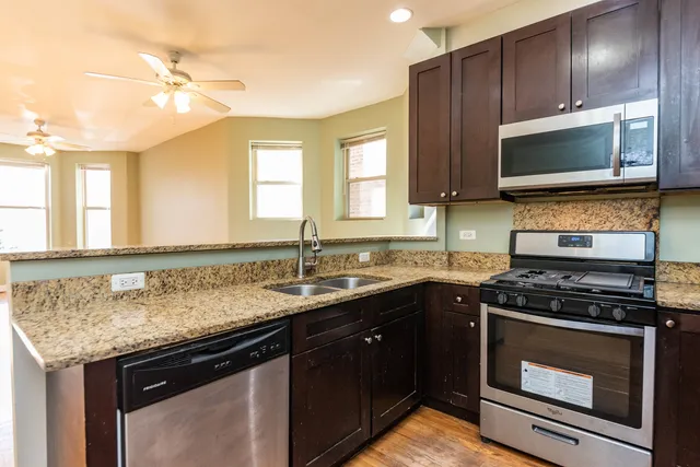a kitchen with a sink stove and microwave