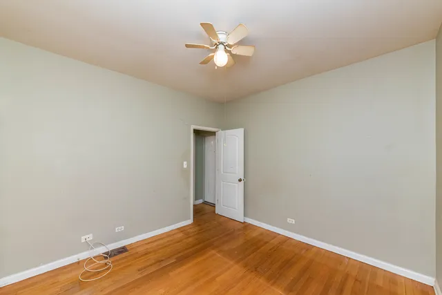 an empty room with closet and fan