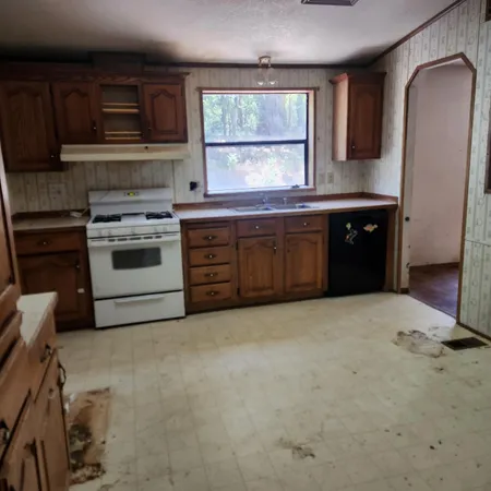 a kitchen with a stove a sink and a microwave