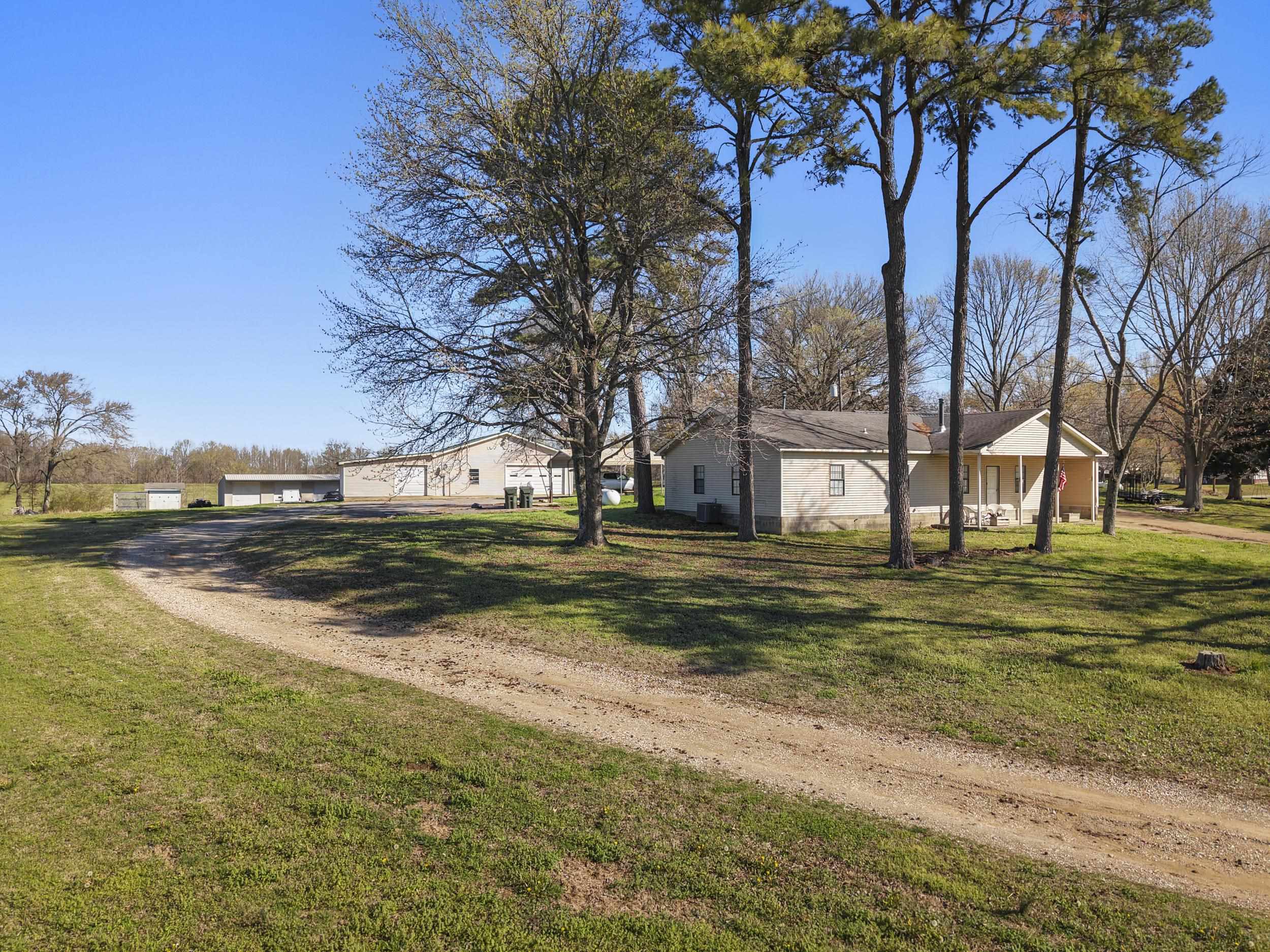 2142 Highway 70 Mason, TN 38049 - Photo 10 of 38 View of green lawn with driveway and a garage